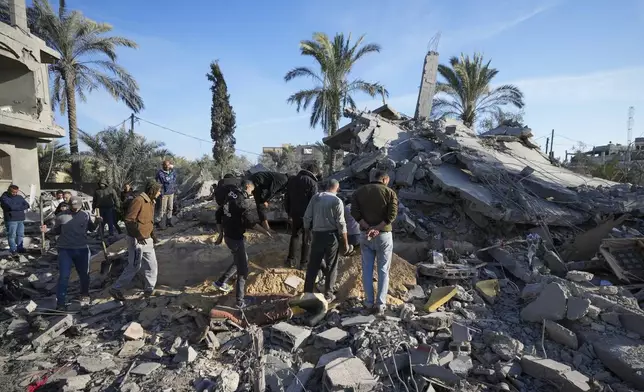 Palestinians look at home destroyed by an Israeli strike late Saturday in Deir al-Balah Sunday, Dec. 22, 2024. At least eight people were killed according to the hospital which received the bodies.(AP Photo/Abdel Kareem Hana)