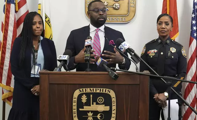 Mayor Paul Young, center, speaks during a news conference with Tannera Gibson, left, and Police Chief Cerelyn "C.J." Davis, right, Thursday, Dec. 5, 2024, in Memphis, Tenn. (AP Photo/George Walker IV)