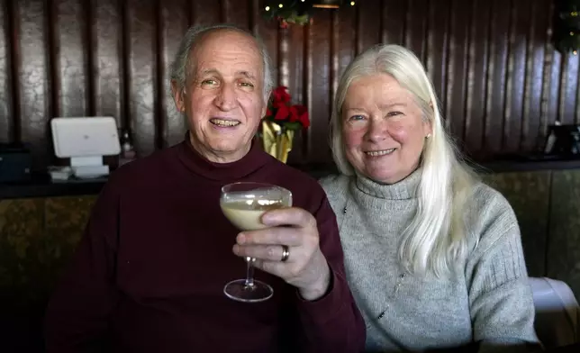 Phil and Laurie Kenny drink eggnog at Scoma's Restaurant in San Francisco on Dec. 10, 2024. The eggnog is prepared 11 months in advance. (AP Photo/Terry Chea)