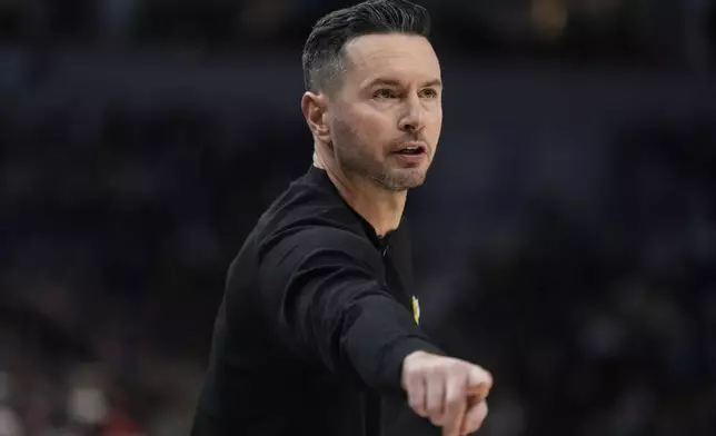 Los Angeles Lakers head coach JJ Redick points during the first half of an NBA basketball game against the Minnesota Timberwolves, Monday, Dec. 2, 2024, in Minneapolis. (AP Photo/Abbie Parr)