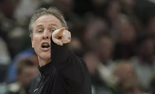 Washington Wizards head coach Brian Keefe gestures from the sideline during the first half of an NBA basketball game against the Milwaukee Bucks, Saturday, Nov. 30, 2024, in Milwaukee. (AP Photo/Aaron Gash)