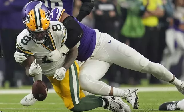 Green Bay Packers' Josh Jacobs fumbles as he is hit by Minnesota Vikings' Jerry Tillery during the first half of an NFL football game Sunday, Dec. 29, 2024, in Minneapolis. (AP Photo/Abbie Parr)