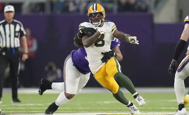 Minnesota Vikings' Jonathan Bullard stops Green Bay Packers' Josh Jacobs during the first half of an NFL football game Sunday, Dec. 29, 2024, in Minneapolis. (AP Photo/Abbie Parr)