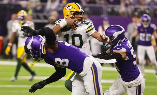 Green Bay Packers' Jordan Love scrambles during the second half of an NFL football game against the Minnesota Vikings Sunday, Dec. 29, 2024, in Minneapolis. (AP Photo/Bruce Kluckhohn)