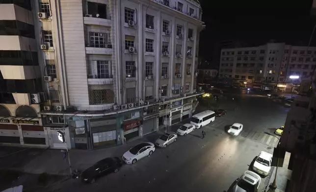 FILE - A car travels down a deserted street in Damascus, Syria, Saturday, Dec. 7, 2024. (AP Photo/Omar Sanadiki, File)