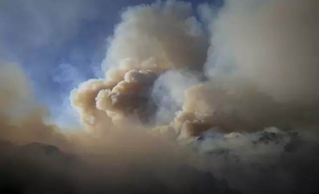 The Franklin Fire sends a plume of smoke into the sky Tuesday, Dec. 10, 2024, in Malibu, Calif. (AP Photo/Eric Thayer)