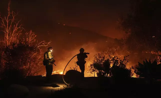 Firefighters battle the Franklin Fire in Malibu, Calif., Tuesday, Dec. 10, 2024. (AP Photo/Jae C. Hong)