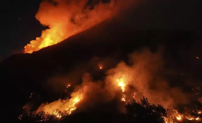 Flames erupt on a mountain as the Franklin Fire burns in Malibu, Calif., Tuesday, Dec. 10, 2024. (AP Photo/Jae C. Hong)