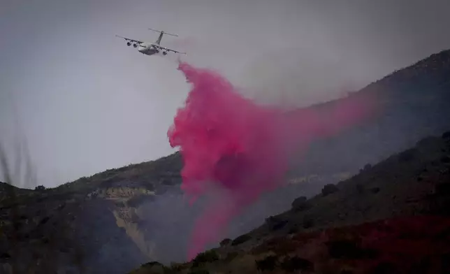 Retardant is dropped onto the Franklin Fire Wednesday, Dec. 11, 2024, in Malibu, Calif. (AP Photo/Eric Thayer)