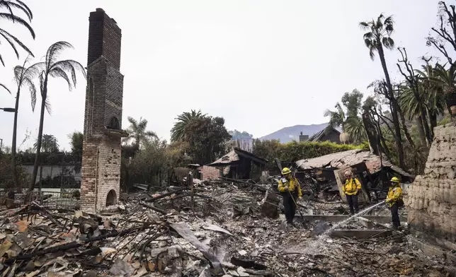 Firefighters work at a home devastated by the Franklin Fire in Malibu, Calif., Wednesday, Dec. 11, 2024. (AP Photo/Jae C. Hong)