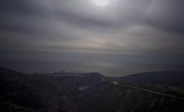 A mountain top overlooking the Pacific Ocean is scarred after the Franklin Fire swept through Wednesday, Dec. 11, 2024, in Malibu, Calif. (AP Photo/Eric Thayer)