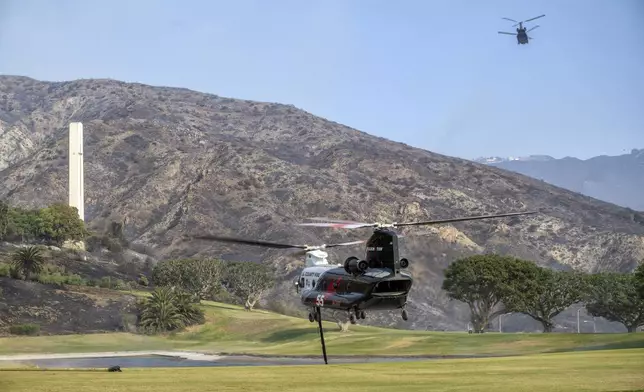 Firefighting helicopters fill their water tanks from a pond on the campus of Pepperdine University while battling the Franklin Fire on Tuesday, Dec. 10, 2024. (Hans Gutknecht/The Orange County Register via AP)