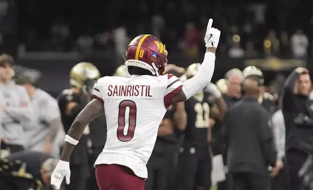 Washington Commanders cornerback Mike Sainristil (0) celebrates a win after an NFL football game against the New Orleans Saints in New Orleans, Sunday, Dec. 15, 2024. (AP Photo/Gerald Herbert)