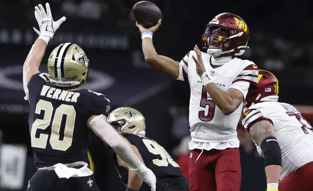 Washington Commanders quarterback Jayden Daniels (5) throws a touchdown pass in the first half of an NFL football game against the New Orleans Saints in New Orleans, Sunday, Dec. 15, 2024. (AP Photo/Butch Dill)