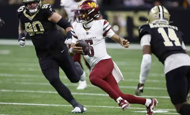 Washington Commanders quarterback Jayden Daniels (5) runs the ball in the second half of an NFL football game against the New Orleans Saints in New Orleans, Sunday, Dec. 15, 2024. (AP Photo/Butch Dill)