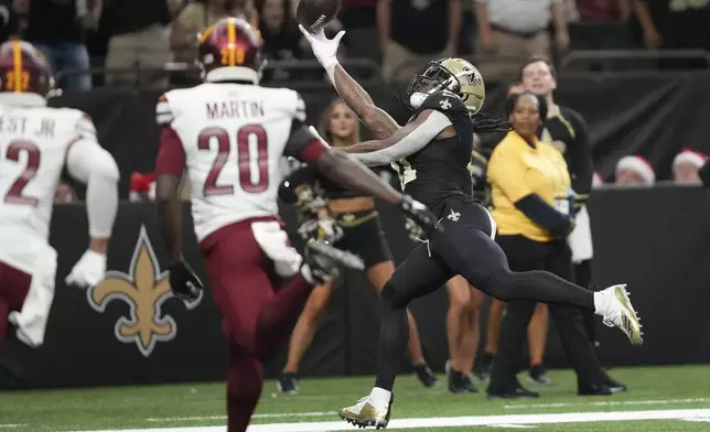 New Orleans Saints running back Alvin Kamara (41) scores a touchdown in the second half of an NFL football game against the Washington Commanders in New Orleans, Sunday, Dec. 15, 2024. (AP Photo/Gerald Herbert)