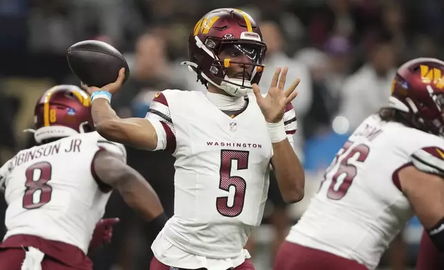 Washington Commanders quarterback Jayden Daniels (5) sets back to pass the ball in the first half of an NFL football game against the New Orleans Saints in New Orleans, Sunday, Dec. 15, 2024. (AP Photo/Gerald Herbert)