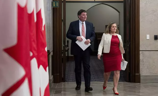 Minister of Finance and Deputy Prime Minister Chrystia Freeland, right, and Minister of Public Safety, Democratic Institutions and Intergovernmental Affairs Dominic LeBlanc arrive for a press conference on Parliament Hill in Ottawa, Ontario, Wednesday, Dec. 11, 2024. (Spencer Colby/The Canadian Press via AP)