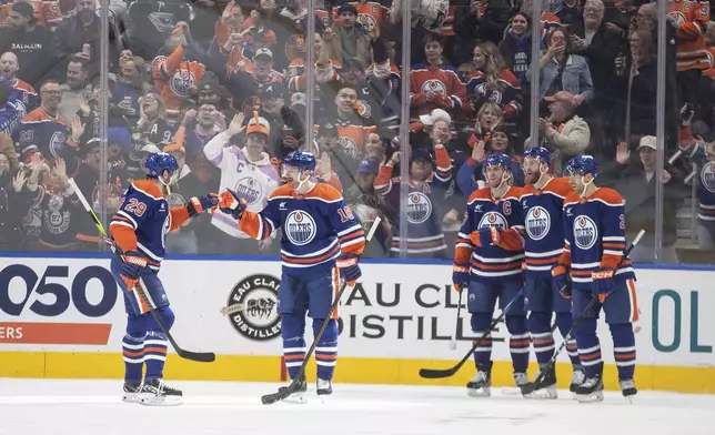 Edmonton Oilers' Leon Draisaitl (29), Zach Hyman (18), Connor McDavid (97), Mattias Ekholm (14) and Evan Bouchard (2) celebrate after a goal against the Florida Panthers during first-period NHL hockey game action in Edmonton, Alberta, Monday, Dec. 16, 2024. (Jason Franson/The Canadian Press via AP)