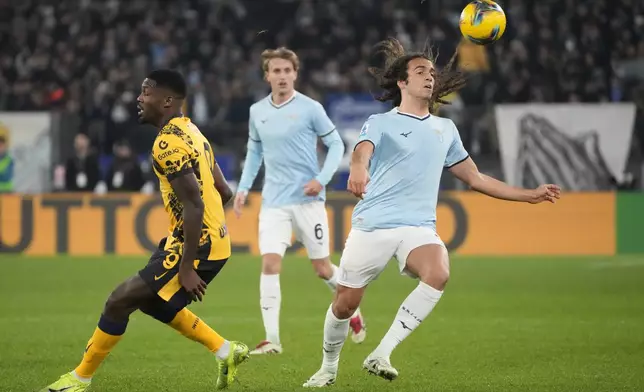 Lazio's Matteo Guendouzi, right, and Inter Milan's Marcus Thuram, left, in action during the Italian Serie A soccer match between Lazio and Inter at Rome's Olympic Stadium, Rome, Italy, Monday, Dec. 16, 2024. (AP Photo/Gregorio Borgia)