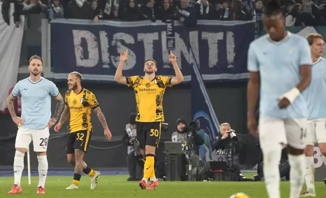 Inter Milan's Carlos Augusto, centre, celebrates after scoring his side's fifth goal during the Italian Serie A soccer match between Lazio and Inter at Rome's Olympic Stadium, Rome, Italy, Monday, Dec. 16, 2024. (AP Photo/Gregorio Borgia)