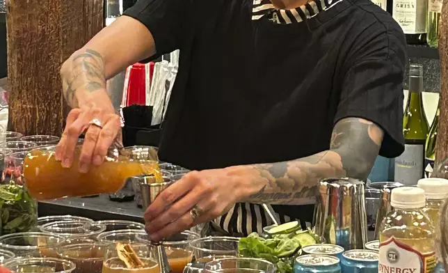 Bartender Patty Burns makes a drink called the Fall Apple Spritz, made with a spiced simple syrup, orange juice, lime juice, apple cider and club soda, during a mocktail making class in Waitsfield, Vt., on Oct. 28, 2024. (AP Photo/Carolyn Lessard)