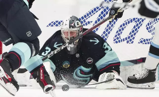 Seattle Kraken goaltender Philipp Grubauer blocks a shot against the Utah Hockey Club during the second period of an NHL hockey game Monday, Dec. 30, 2024, in Seattle. (AP Photo/Lindsey Wasson)