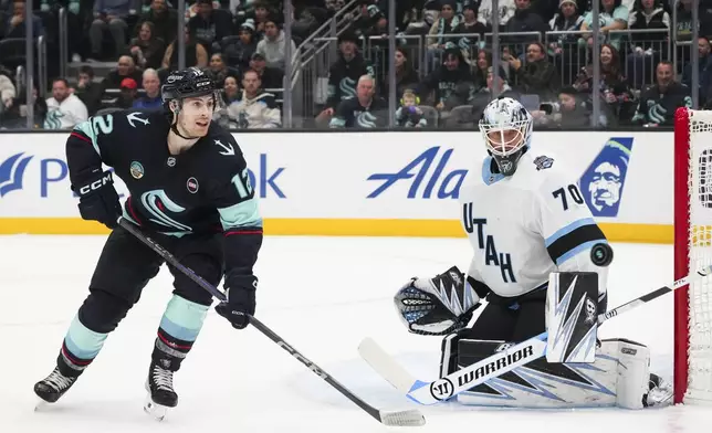 Seattle Kraken left wing Tye Kartye watches his shot deflect against Utah Hockey Club goaltender Karel Vejmelka (70) during the second period of an NHL hockey game Monday, Dec. 30, 2024, in Seattle. (AP Photo/Lindsey Wasson)