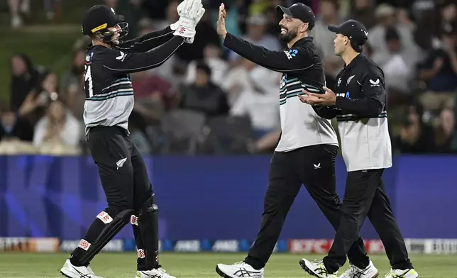 Sri Lanka players celebrate dismissing New ZNew Zealand's Mitch Hay and Daryl Mitchell celebrate the dismissal of Sri Lanka's Kusal Mendis, during the second Twenty20 international cricket match between New Zealand and Sri Lanka at Mt. Maunganui, New Zealand Monday, Dec. 30, 2024. (Andrew Cornaga/Photosport via AP)