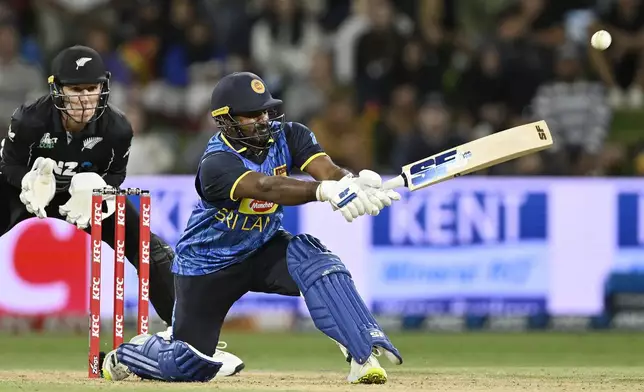 Sri Lanka's Kusal Perera as New Zealand's Mitch Hay looks on, during the second Twenty20 international cricket match between New Zealand and Sri Lanka at Mt. Maunganui, New Zealand Monday, Dec. 30, 2024. (Andrew Cornaga/Photosport via AP)