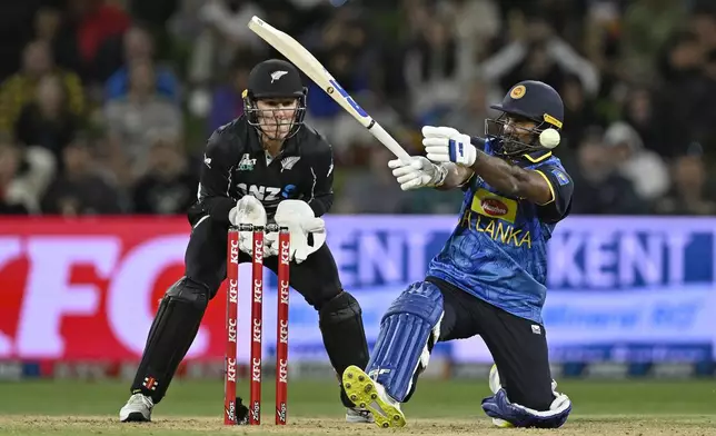 Sri Lanka's Kusal Perera bats as New Zealand's Mitch Hay looks on, during the second Twenty20 international cricket match between New Zealand and Sri Lanka at Mt. Maunganui, New Zealand Monday, Dec. 30, 2024. (Andrew Cornaga/Photosport via AP)