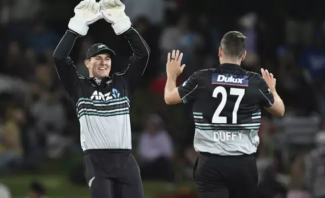 New Zealand's Mitch Hay and Jacob Duffy celebrate the wicket of Sri Lanka's Kusal Perera, during the second Twenty20 international cricket match between New Zealand and Sri Lanka at Mt. Maunganui, New Zealand Monday, Dec. 30, 2024. (Andrew Cornaga/Photosport via AP)