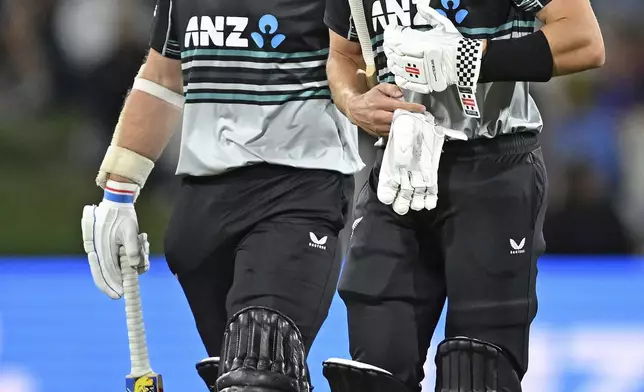 New Zealand's Michael Bracewell and Mitch Hay walk, at the completion of their innings, during the second Twenty20 international cricket match between New Zealand and Sri Lanka at Mt. Maunganui, New Zealand Monday, Dec. 30, 2024. (Andrew Cornaga/Photosport via AP)