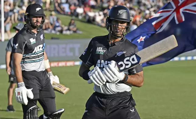 New Zealand's Tim Robinson and New Zealand's Rachin Ravindra head out to bat during the second Twenty20 international cricket match between New Zealand and Sri Lanka at Mt. Maunganui, New Zealand Monday, Dec. 30, 2024. (Andrew Cornaga/Photosport via AP)