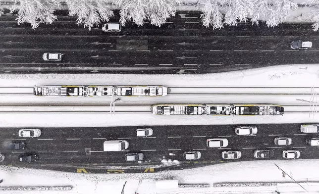 An aerial view of the city traffic during heavy snowfall in Sarajevo, Bosnia, Tuesday, Dec. 24, 2024. (AP Photo/Armin Durgut)