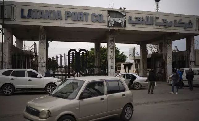 A car drives past the entrance of the port of Latakia, Syria, Monday, Dec. 16, 2024. (AP Photo/Leo Correa)