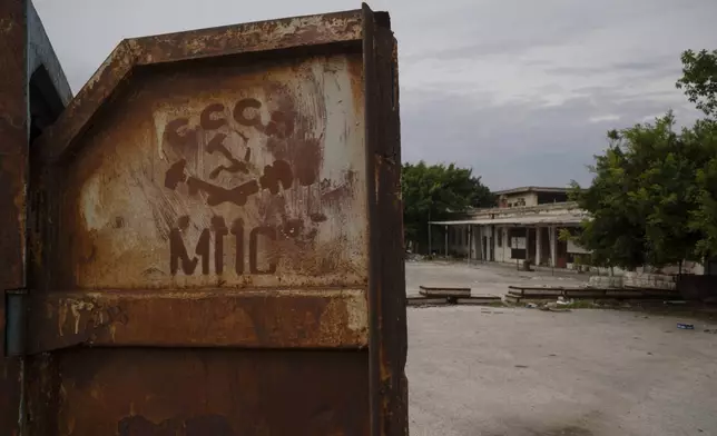 A Soviet Union symbol is seen on a old small container at the entrance of a Syrian Navy area in the port of Latakia, Syria, Monday, Dec. 16, 2024. (AP Photo/Leo Correa)