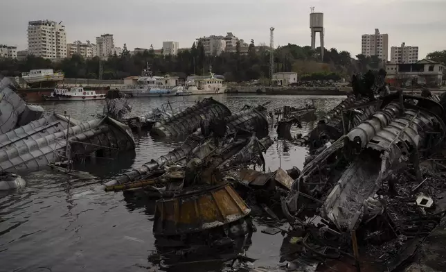 Destroyed Syrian naval vessels from previous Israeli airstrikes are seen in the port of Latakia, Syria, Monday, Dec. 16, 2024. (AP Photo/Leo Correa)