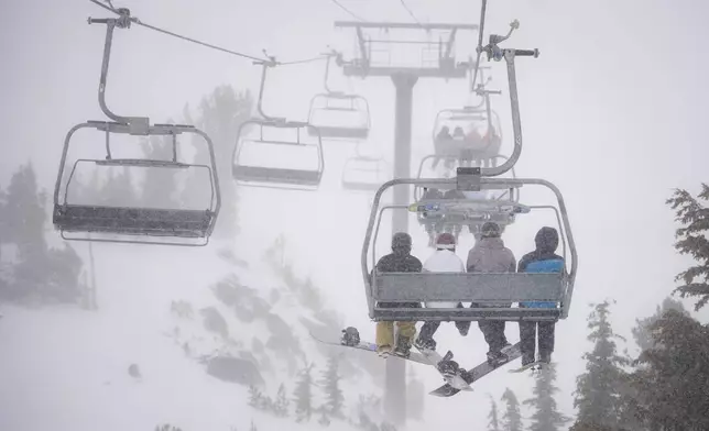 FILE - Skiers go up a lift in a snowstorm on Mammoth Mountain in Mammoth Lakes, Calif., Dec. 14, 2024. (Christian Pondella/Mammoth Mountain Ski Area via AP, File)