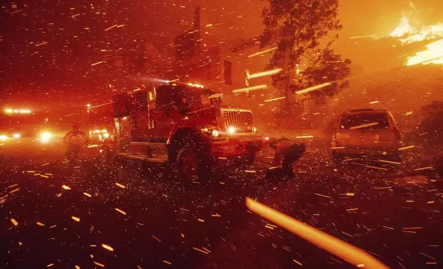 FILE - Firefighters battle the Franklin Fire in Malibu, Calif., Dec. 10, 2024. (AP Photo/Ethan Swope)