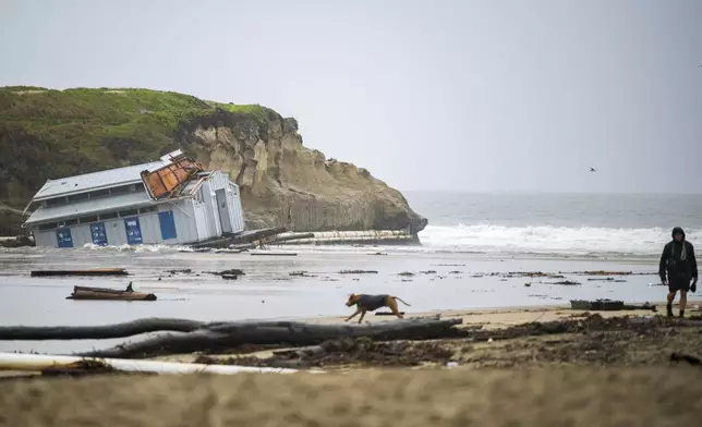 Remnants of a bathroom that fell off the wharf are visible at the mouth of the San Lorenzo River in Santa Cruz, Calif., Tuesday, Dec. 24, 2024. (AP Photo/Nic Coury)