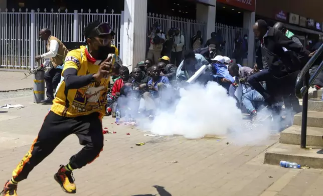 A man reacts after being tear-gassed by police during protests against abductions dubbed 'EndProtests' in Nairobi, Kenya, Monday, Dec. 30, 2024. (AP Photo/Andrew Kasuku)