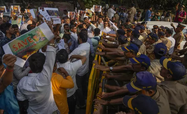 Members of Vishwa Hindu Parishad (VHP) shout slogans as they are stopped by police during a protest outside the Bangladesh High Commission in Mumbai, India, Monday, Dec. 2, 2024. (AP Photo/Rafiq Maqbool)