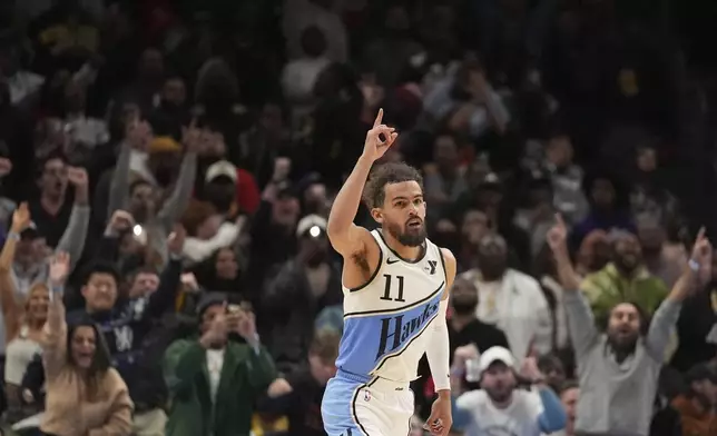 Atlanta Hawks guard Trae Young (11) celebrates after he scores, winning an NBA basketball game against the Los Angeles Lakers, Friday, Dec. 6, 2024, in Atlanta. (AP Photo/Brynn Anderson)