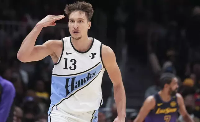 Atlanta Hawks guard Bogdan Bogdanovic (13) celebrates after scoring in the second half of an NBA basketball game against the Los Angeles Lakers, Friday, Dec. 6, 2024, in Atlanta. (AP Photo/Brynn Anderson)