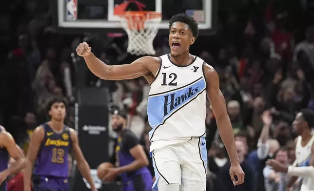 Atlanta Hawks forward De'Andre Hunter (12) reacts after scoring in the second half of an NBA basketball game against the Los Angeles Lakers, Friday, Dec. 6, 2024, in Atlanta. (AP Photo/Brynn Anderson)