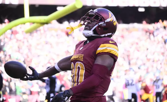 Washington Commanders wide receiver Jamison Crowder (80) celebrates his touchdown against the Philadelphia Eagles during the first half of an NFL football game, Sunday, Dec. 22, 2024, in Landover, Md. (AP Photo/Nick Wass)