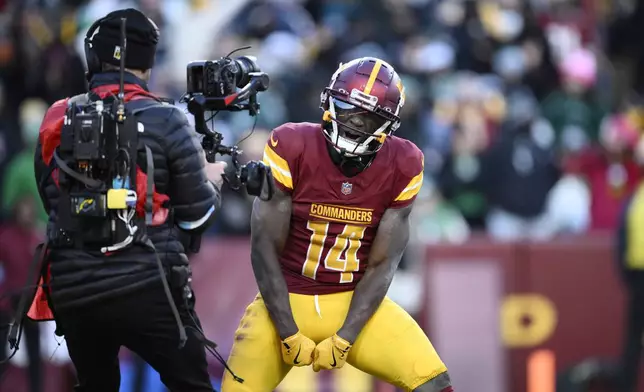 Washington Commanders wide receiver Olamide Zaccheaus (14) celebrating his touchdown against Philadelphia Eagles during the second half of an NFL football game, Sunday, Dec. 22, 2024, in Landover, Md. (AP Photo/Nick Wass)