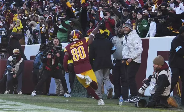 Washington Commanders wide receiver Jamison Crowder (80) scores a touchdown against the Philadelphia Eagles during the first half of an NFL football game, Sunday, Dec. 22, 2024, in Landover, Md. (AP Photo/Stephanie Scarbrough)