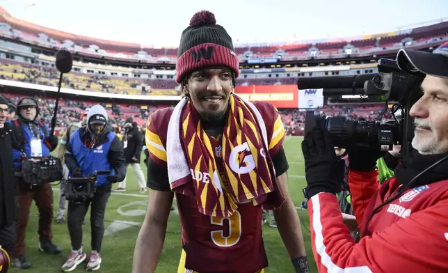 Washington Commanders quarterback Jayden Daniels (5) heads off the field at the end of an NFL football game against the Philadelphia Eagles, Sunday, Dec. 22, 2024, in Landover, Md. (AP Photo/Nick Wass)